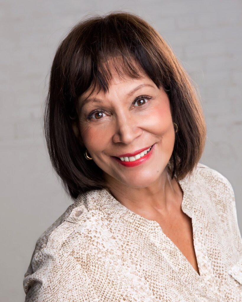 A woman with brown hair and red lipstick.