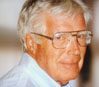 A man with glasses and white hair.
