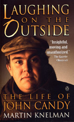A man wearing a hat and jacket is standing outside.