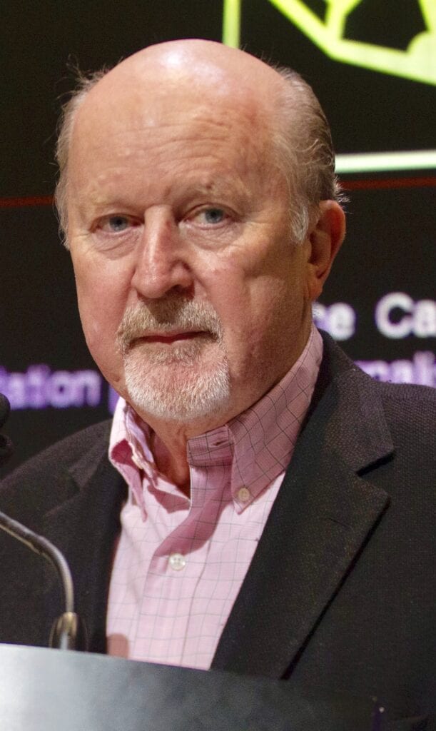 A man with a beard and mustache wearing a suit.