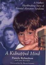 A boy with his head on top of a book.