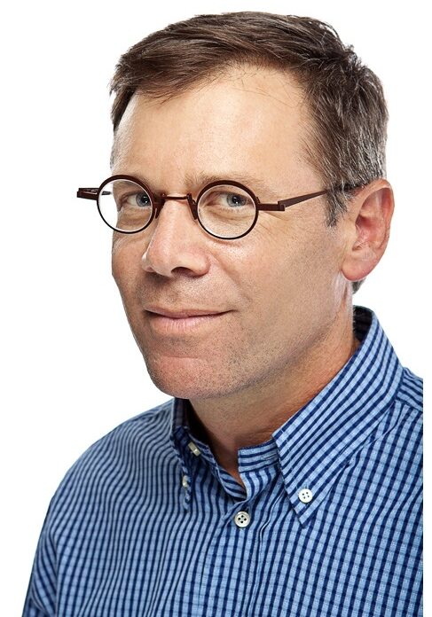 A man with glasses and a blue shirt