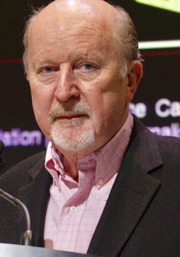 A man with a beard and mustache wearing a suit.