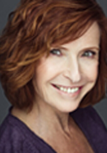 A woman with red hair and a purple shirt
