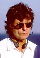 A man with sunglasses and headphones on.