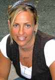 A woman with blonde hair and a white shirt.