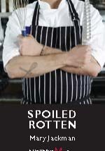 A person with an apron on and crossed arms.