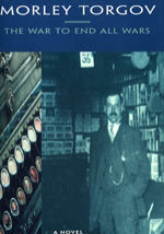 A man in a suit and tie standing next to a bunch of books.