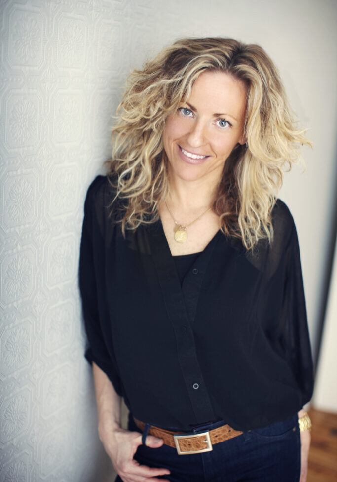 A woman with blonde hair wearing black shirt.