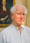A man standing in front of a painting.