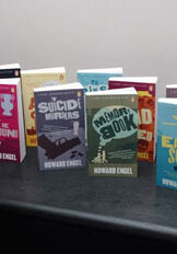 A table topped with lots of books on top of it.