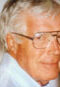 A man with glasses and white hair.